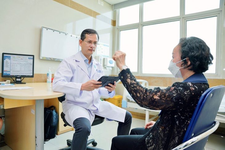 70% người bệnh Parkinson được cải thiện khi được kích thích não sâu- Ảnh 1. Bác sĩ Trần Ngọc Tài đang khám cho người bệnh Parkinson - Ảnh: BVCC